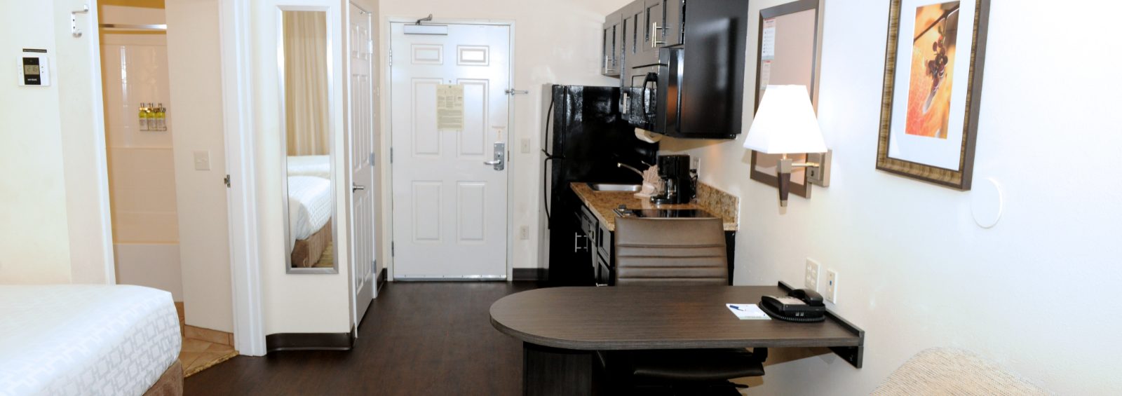 Studio suites with a full kitchen, work desk and queen bed