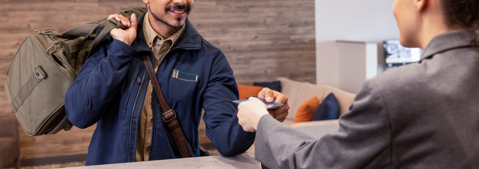 Man checking in a Candlewood Suites Santa Maria CA front desk