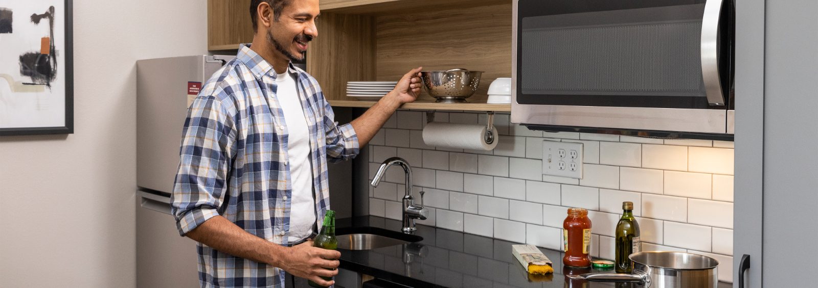 Man cooking in his in-suite kitchen