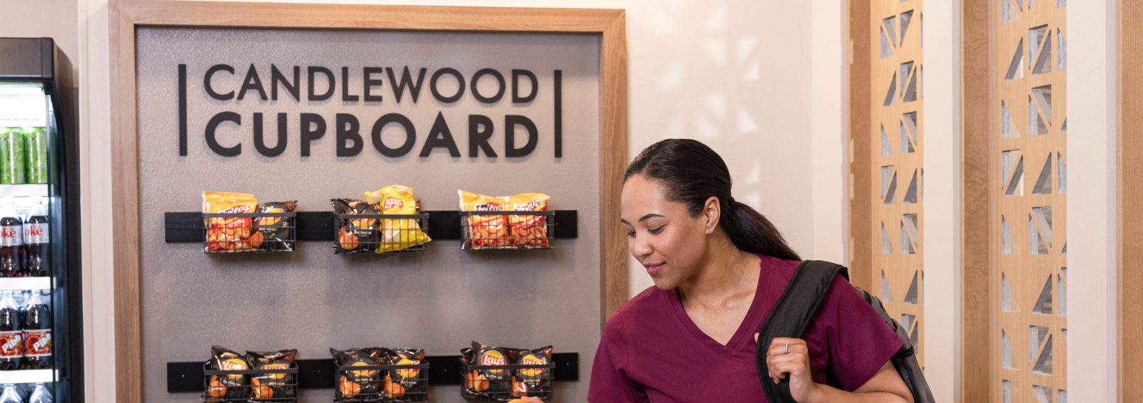 Women picking up snacks at the Candlewood Cupboard