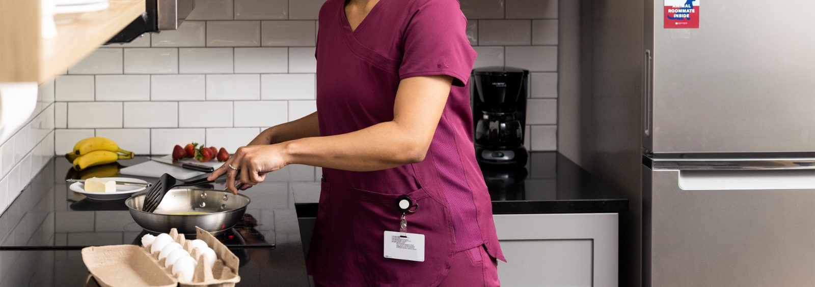 women cooking breakfast in her in-suite kitchen