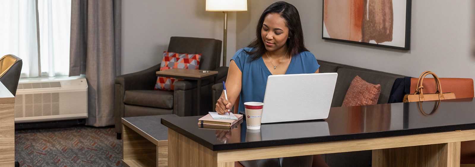 hotel room work desk with female on computer